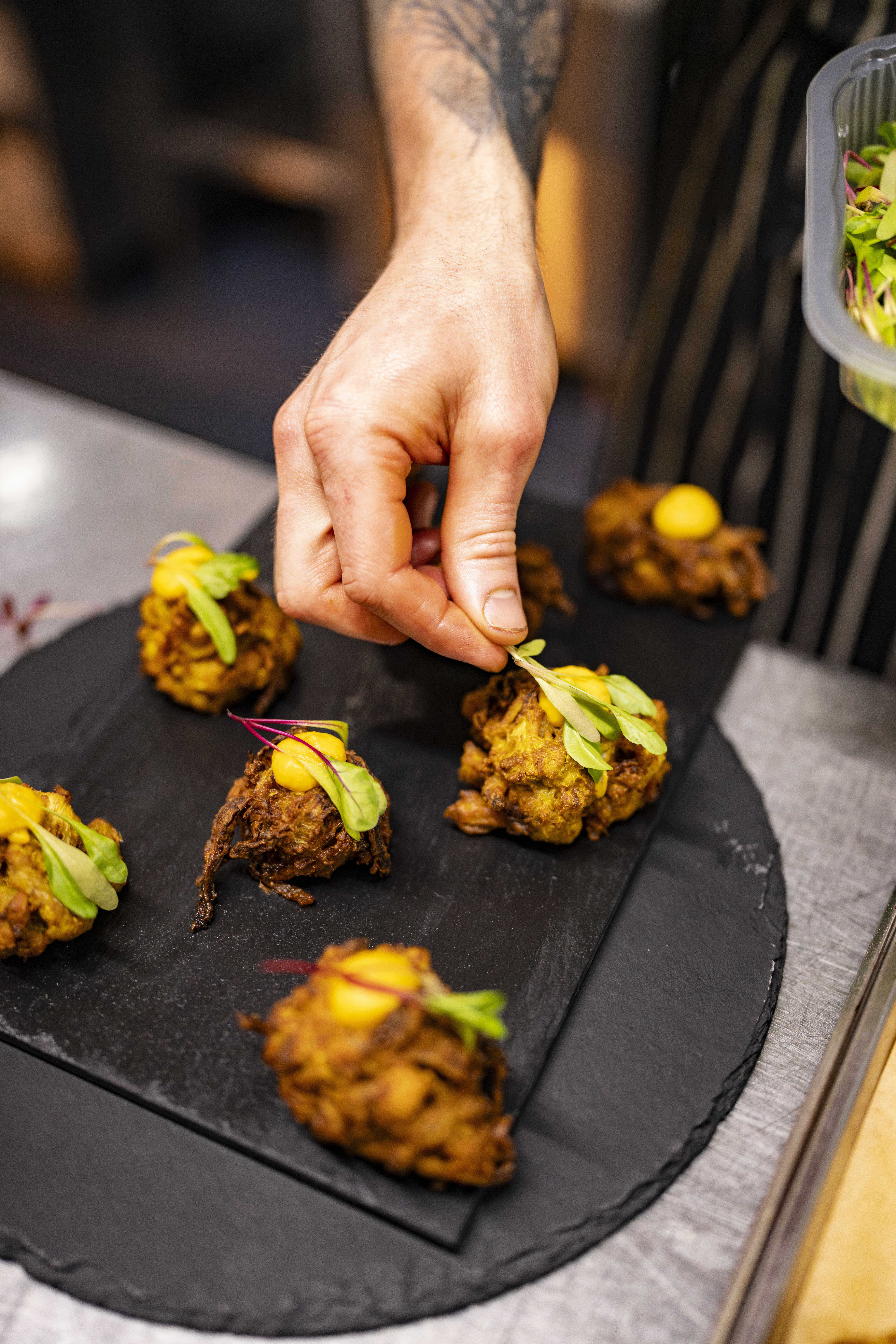 People reaching for appetisers on a plate