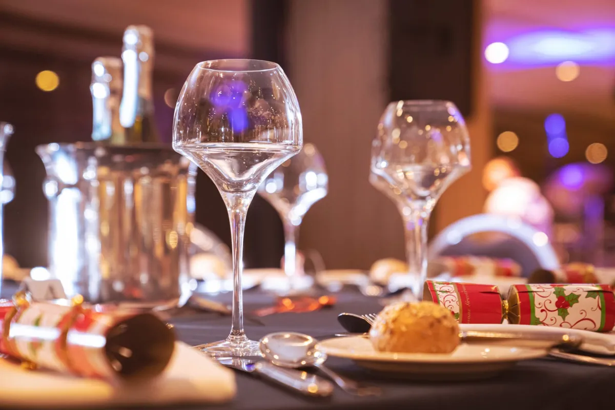 Glasses and christmas crackers on a table