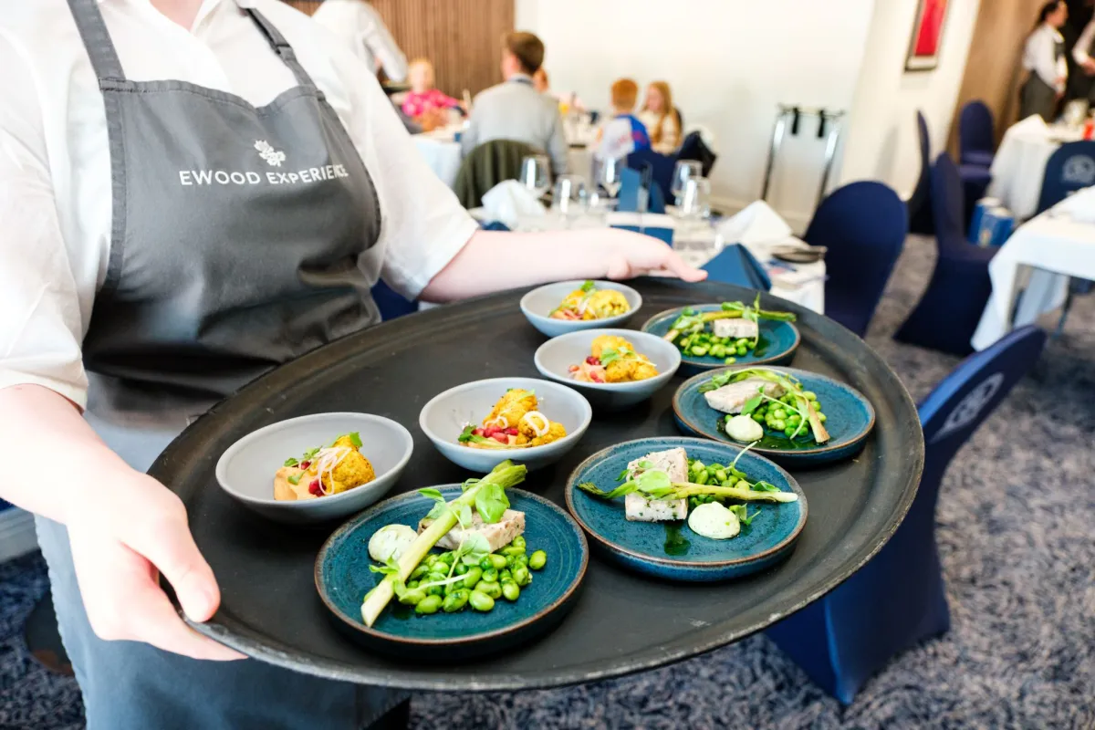 Woman holding a platter of appetisers