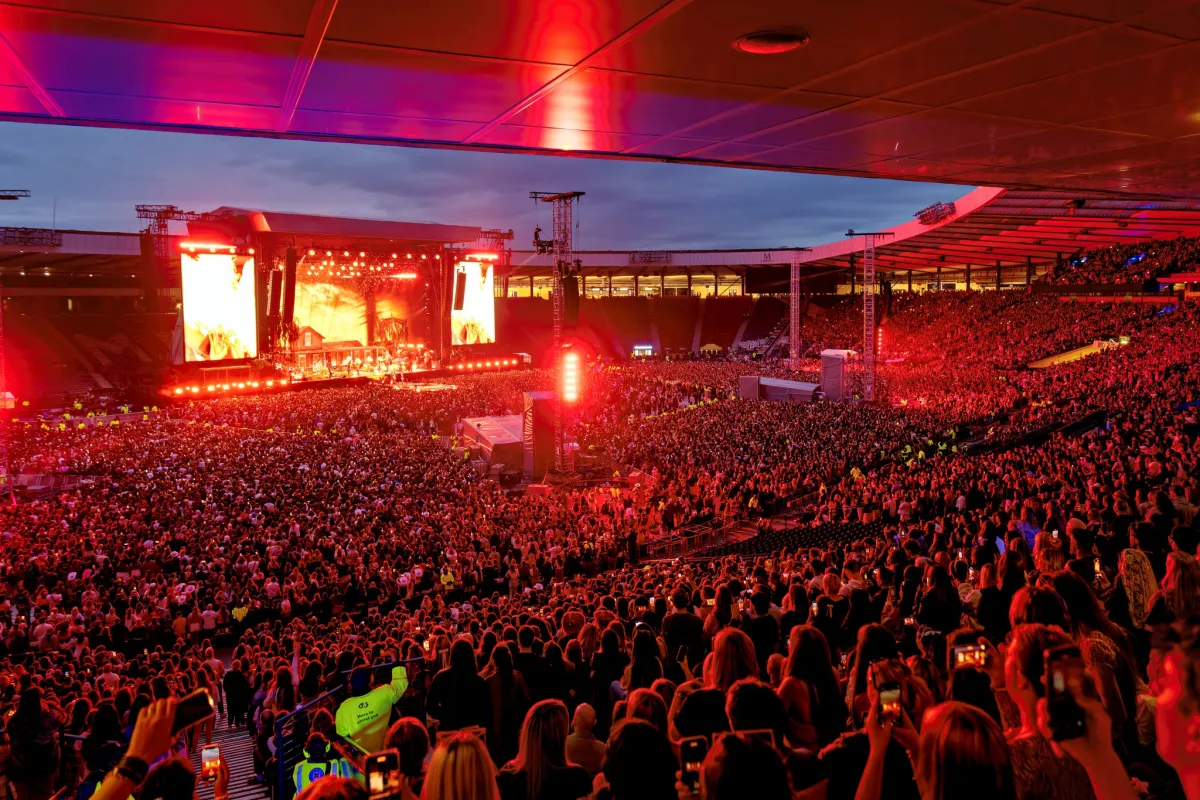 Image of a crowd in front of a stage at a live event