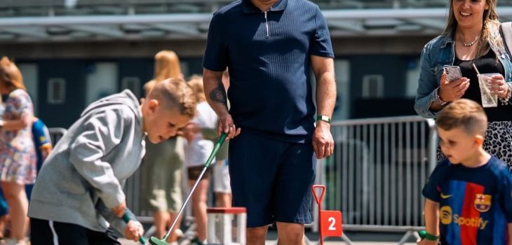 Family enjoying a round of mini golf